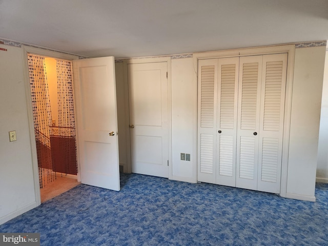 unfurnished bedroom featuring dark carpet