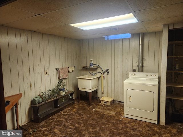 washroom featuring dark colored carpet, washer / dryer, wood walls, and sink