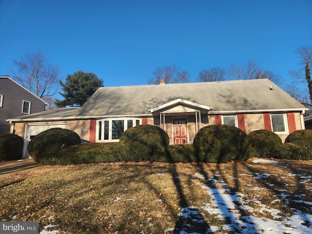 view of front of home with a garage and a yard