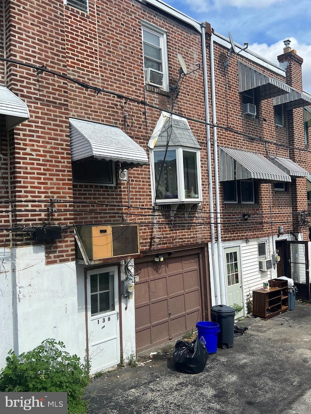 back of house with a garage