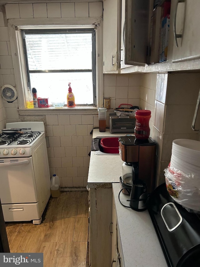 kitchen featuring light wood-type flooring and white gas range