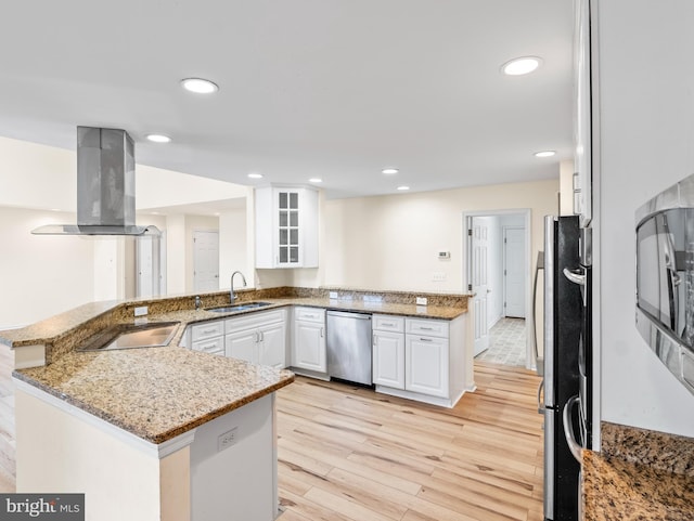 kitchen featuring island exhaust hood, appliances with stainless steel finishes, kitchen peninsula, sink, and white cabinetry