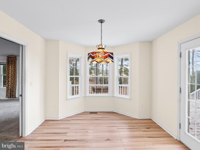 unfurnished dining area featuring light hardwood / wood-style floors