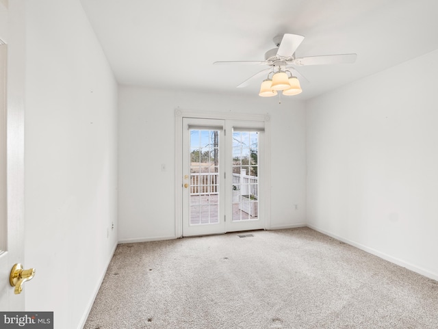 carpeted empty room featuring ceiling fan