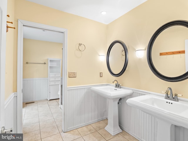 bathroom featuring tile patterned flooring and double sink