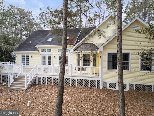 back of property featuring a wooden deck