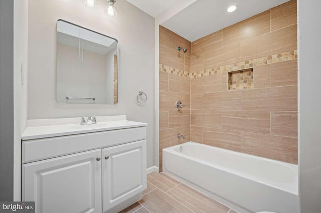 bathroom with tile patterned floors, vanity, and tiled shower / bath