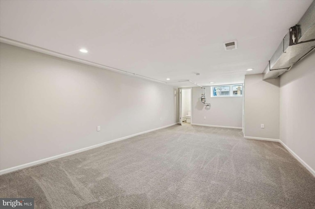 basement featuring light colored carpet