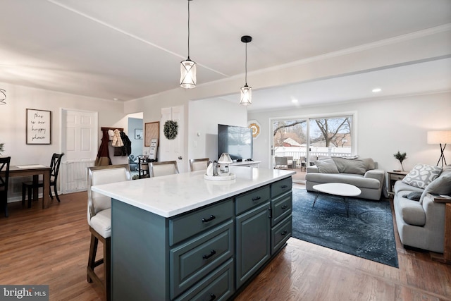 kitchen with dark hardwood / wood-style floors, a center island, and decorative light fixtures