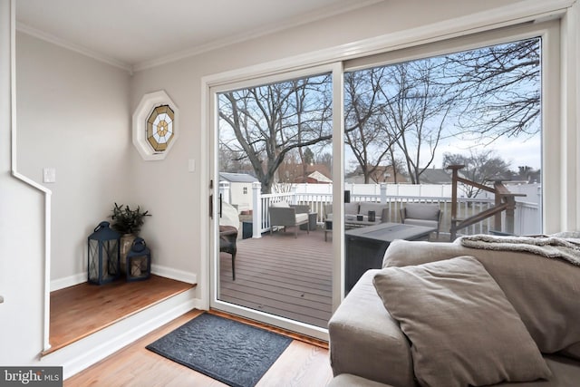 doorway to outside featuring hardwood / wood-style floors and ornamental molding