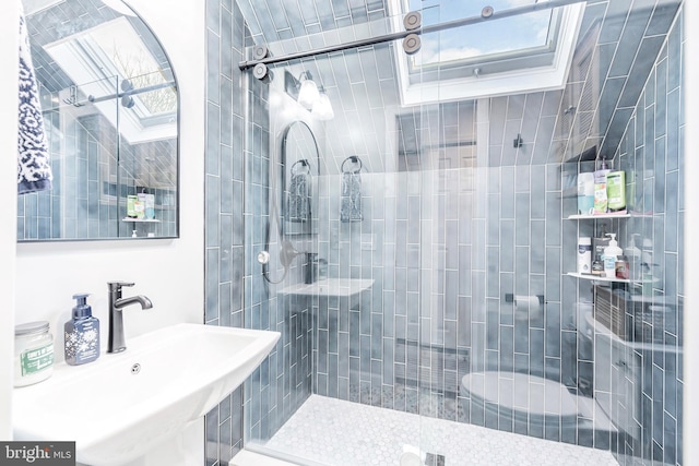 bathroom featuring a tile shower and sink