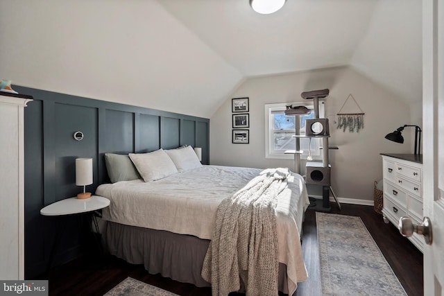 bedroom with dark hardwood / wood-style flooring and lofted ceiling