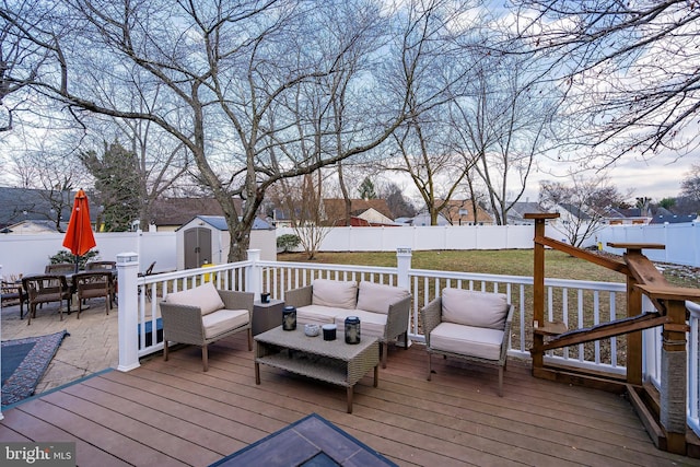 deck with outdoor lounge area and a storage shed