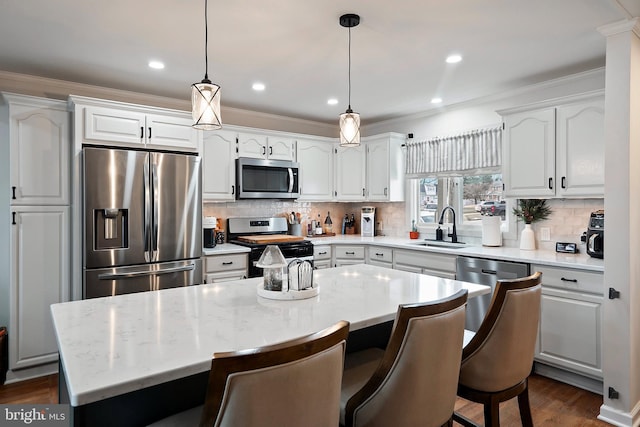 kitchen with white cabinetry, a center island, and appliances with stainless steel finishes