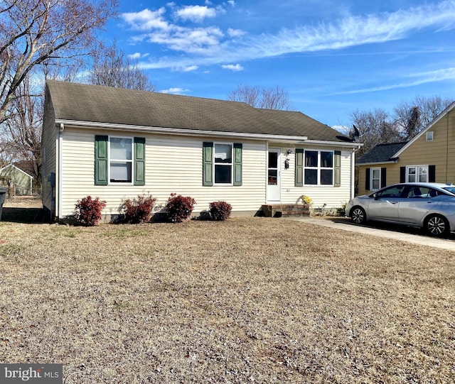 single story home with roof with shingles