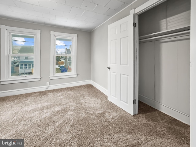 unfurnished bedroom with dark carpet