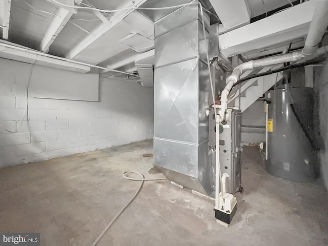 utility room featuring heating unit and water heater