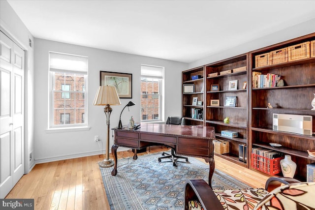 office with light wood-type flooring