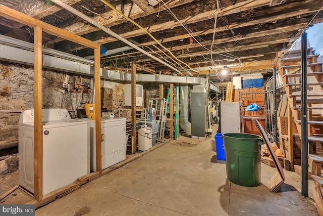 basement with washer and dryer and heating unit