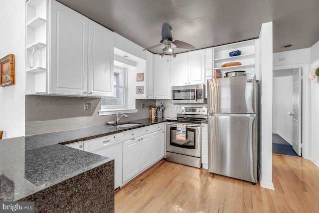 kitchen featuring stainless steel appliances, ceiling fan, white cabinets, and sink