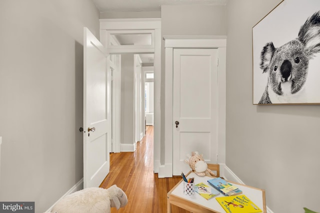 interior space featuring light wood-type flooring and baseboards