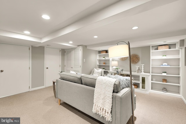 living area featuring recessed lighting, built in shelves, and light colored carpet