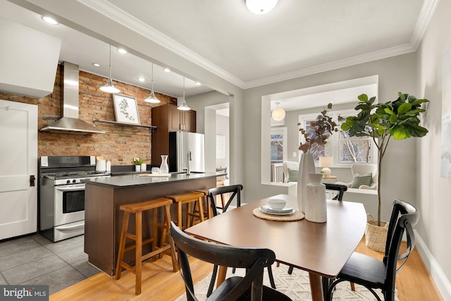 dining space with baseboards and crown molding