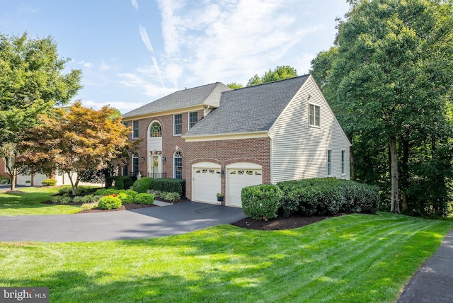 view of front of home featuring a garage and a front yard