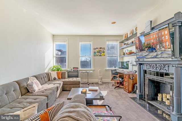 living room featuring a high end fireplace and light carpet