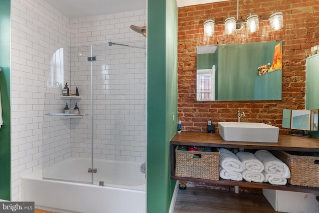 bathroom featuring shower / bath combination with glass door, hardwood / wood-style floors, and vanity