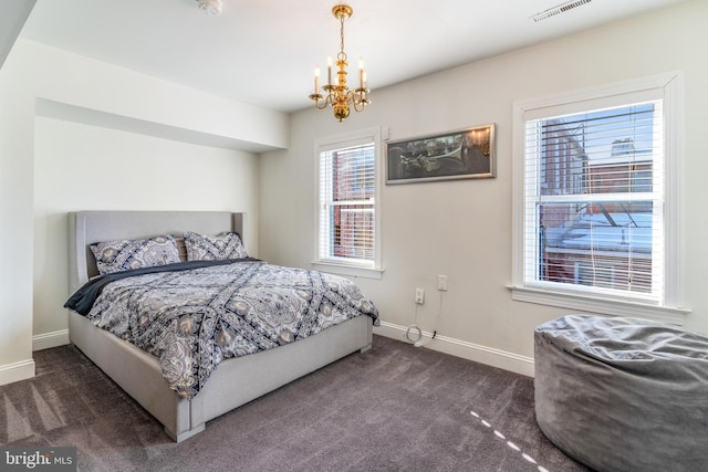 carpeted bedroom featuring a notable chandelier