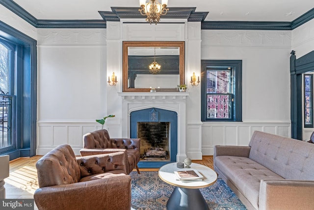 living room featuring ornamental molding, an inviting chandelier, and hardwood / wood-style flooring