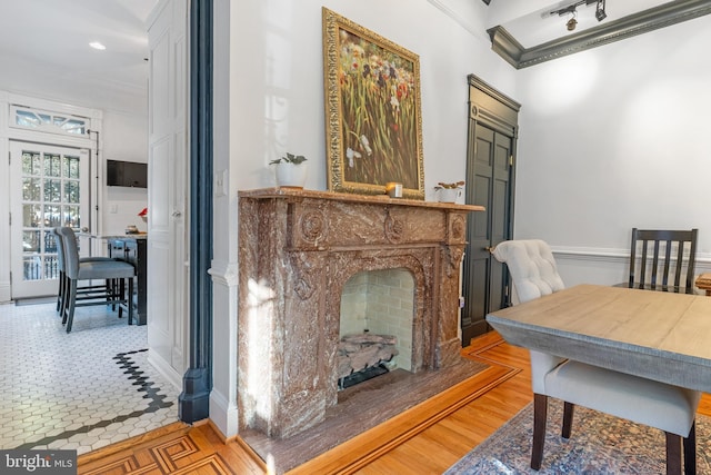 dining space featuring ornamental molding and a fireplace