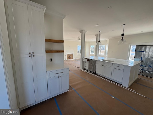 kitchen with white cabinetry, pendant lighting, crown molding, and dishwasher