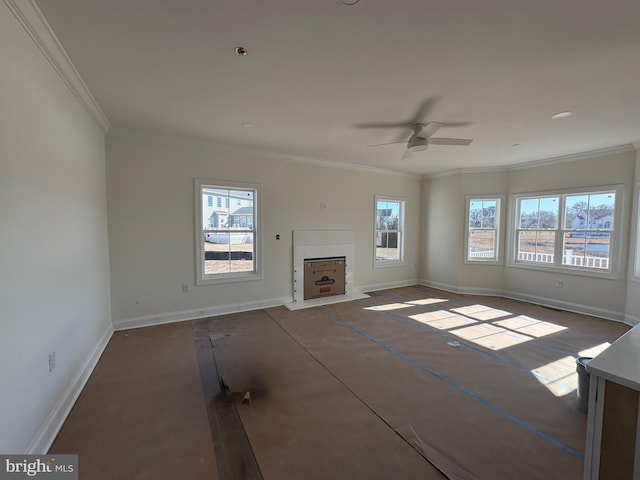 unfurnished living room featuring crown molding, plenty of natural light, and ceiling fan