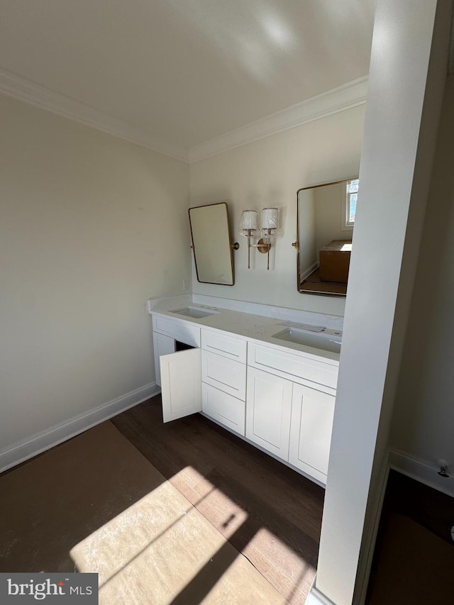 bathroom featuring vanity, crown molding, and hardwood / wood-style flooring