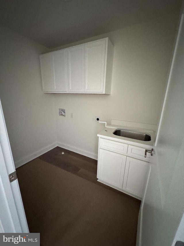 laundry area with dark hardwood / wood-style floors, sink, cabinets, washer hookup, and electric dryer hookup