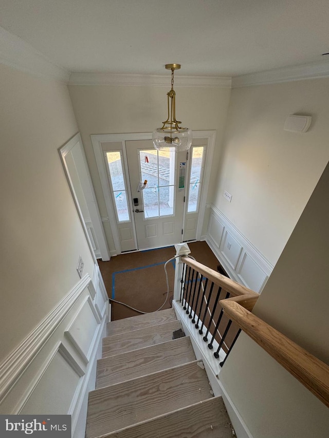 foyer featuring hardwood / wood-style flooring and ornamental molding