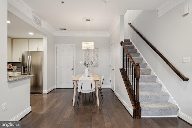 dining room with dark wood-type flooring and ornamental molding