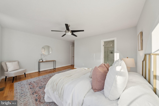 bedroom with hardwood / wood-style floors, connected bathroom, and ceiling fan