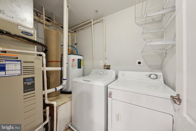 laundry room featuring tile patterned flooring, washer and dryer, and water heater