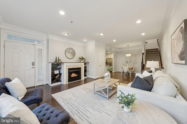 living room featuring dark hardwood / wood-style floors and ornamental molding