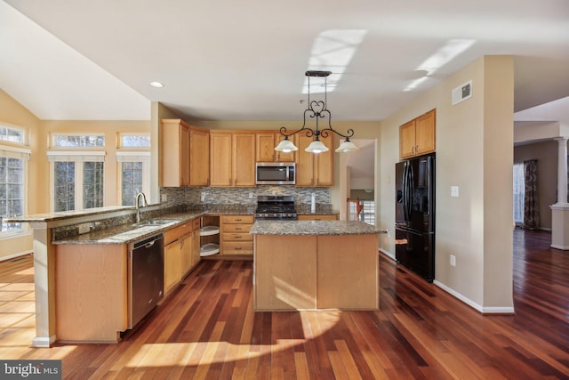 kitchen with decorative light fixtures, a center island, backsplash, and appliances with stainless steel finishes