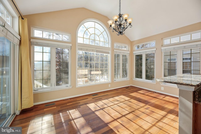 unfurnished sunroom featuring an inviting chandelier, vaulted ceiling, and a wealth of natural light