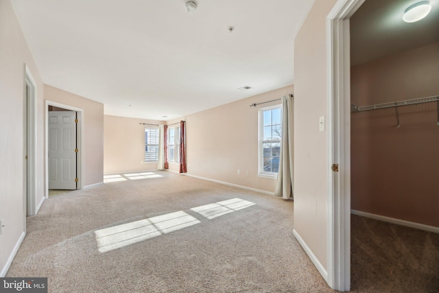 unfurnished bedroom featuring a closet and light carpet