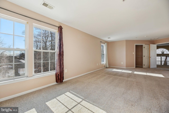 carpeted empty room featuring a healthy amount of sunlight