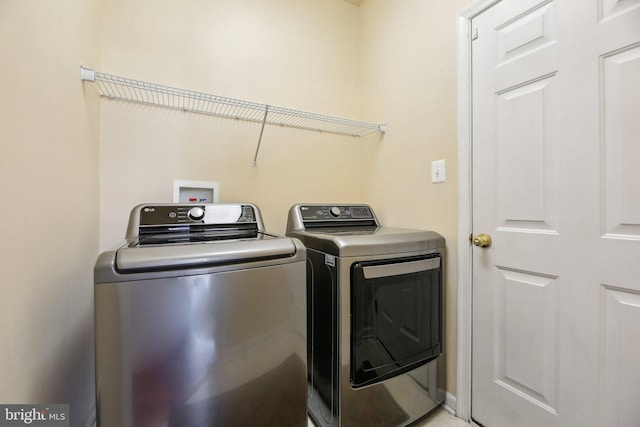 clothes washing area with separate washer and dryer