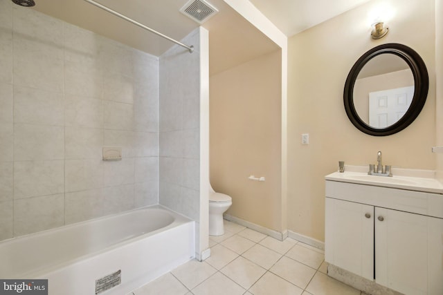 full bathroom featuring toilet, vanity, tile patterned floors, and tiled shower / bath combo