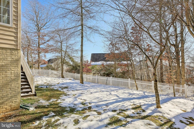 view of yard layered in snow