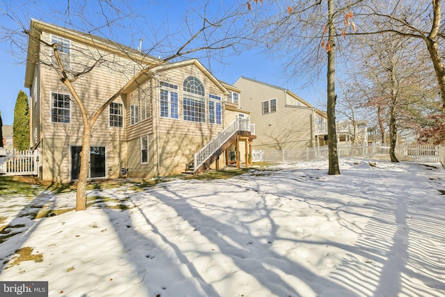 view of snow covered rear of property